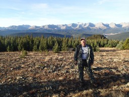 Mark in Alberta Valley with mountain landscape while hunting Bighorn Sheep in Canada